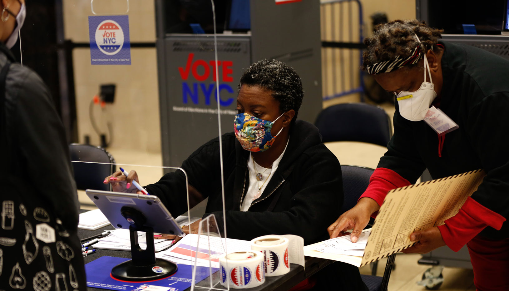 Election workers attend a voter