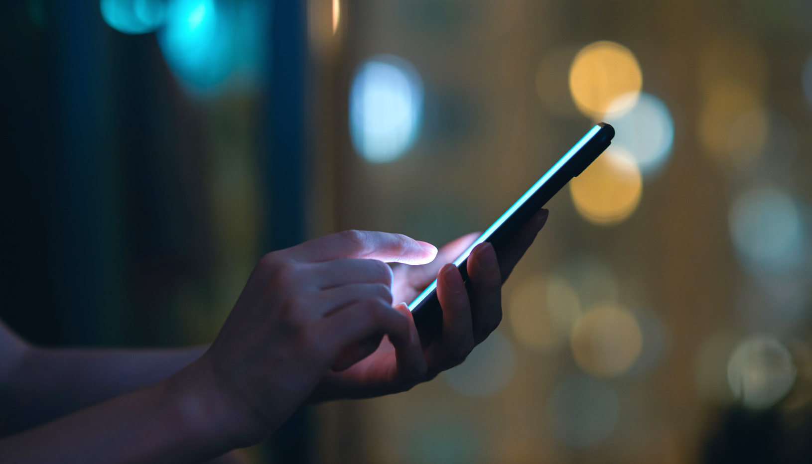 Close-up shot of hands using a cell phone