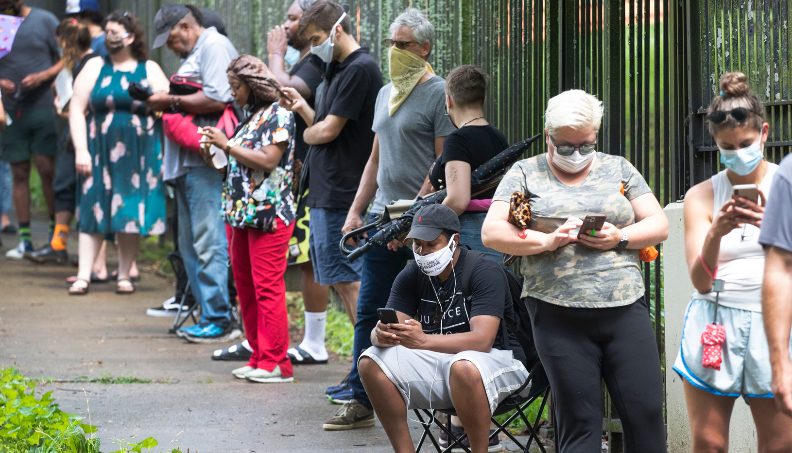 Primary voters stand in a long line to vote