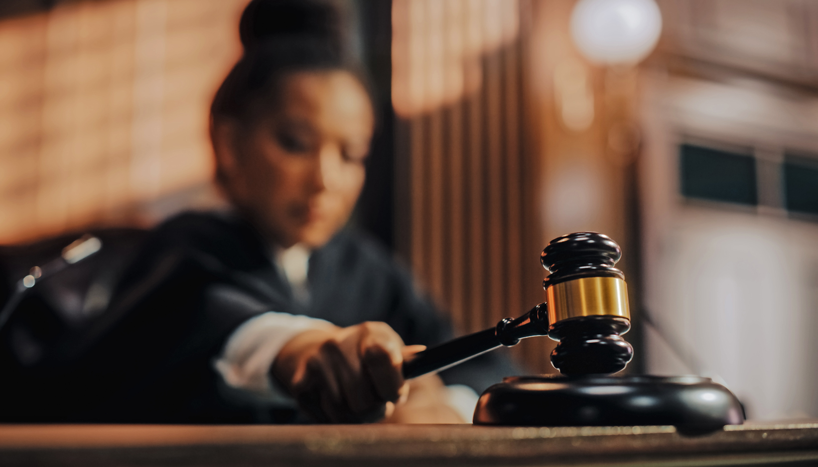 A Black woman judge bangs her gavel