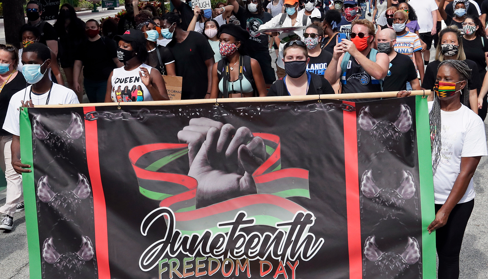 People carrying Juneteenth banner