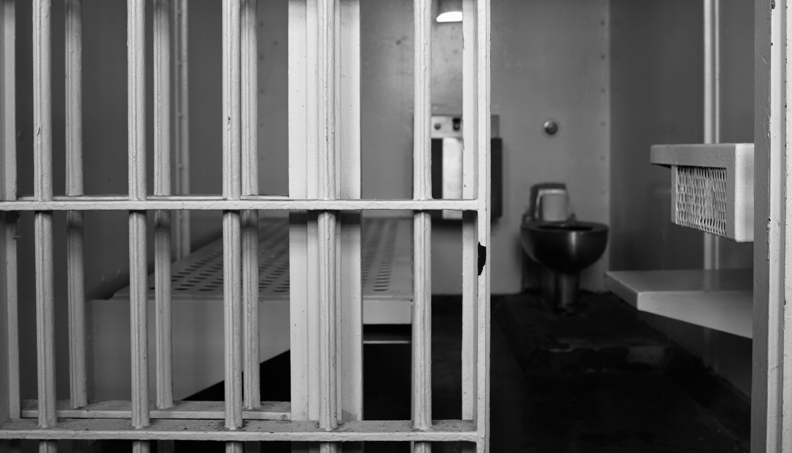 Black and white image of jail cell