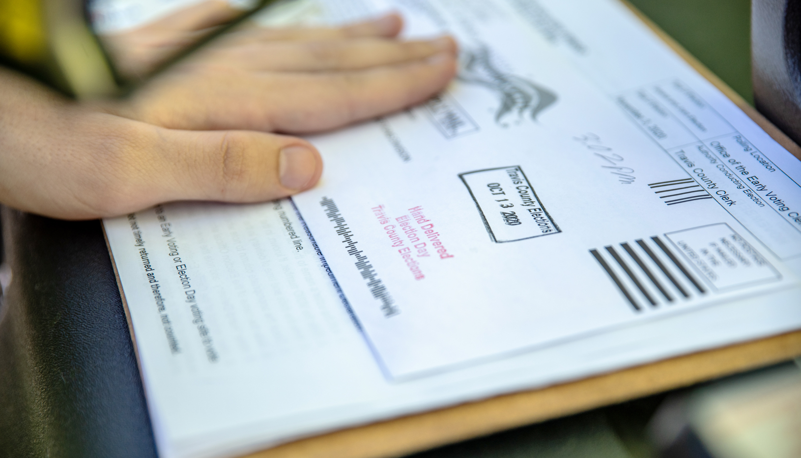Person holding a Texas mail ballot