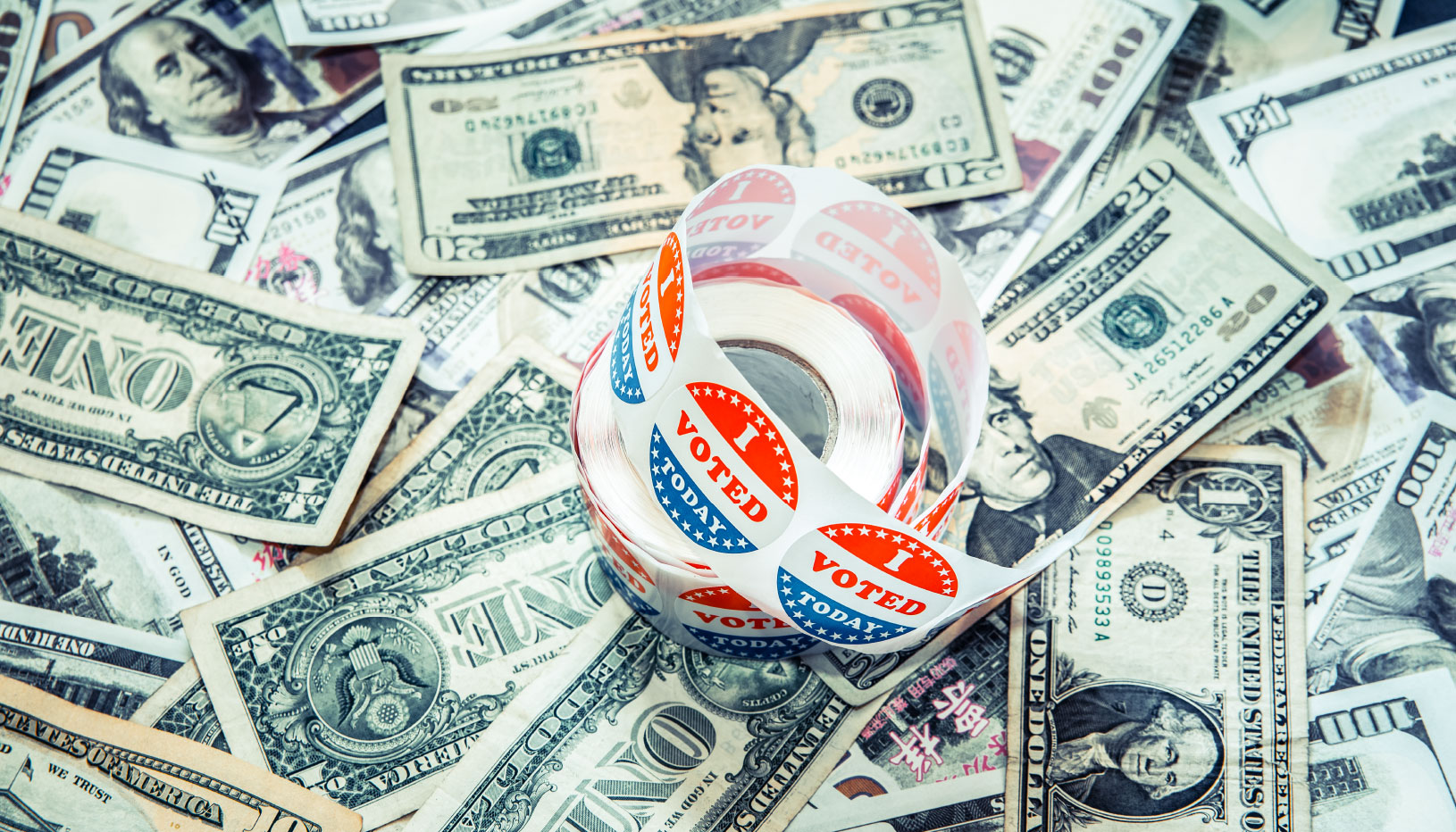 U.S. dollars and roll of "I voted" stickers