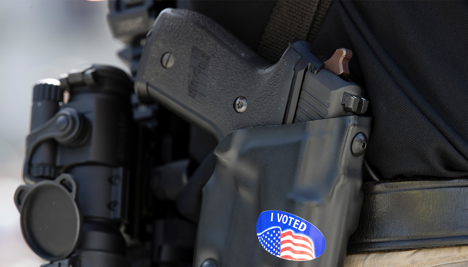 An “I VOTED” sticker on a gun holster.