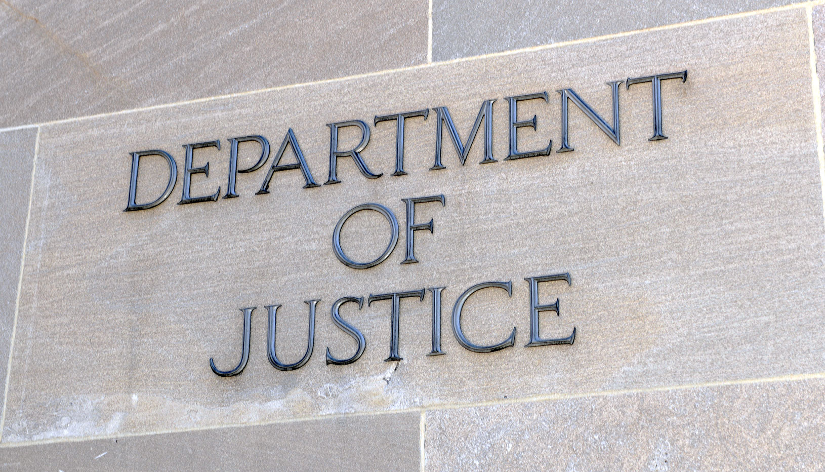 Department of Justice lettering on gray building