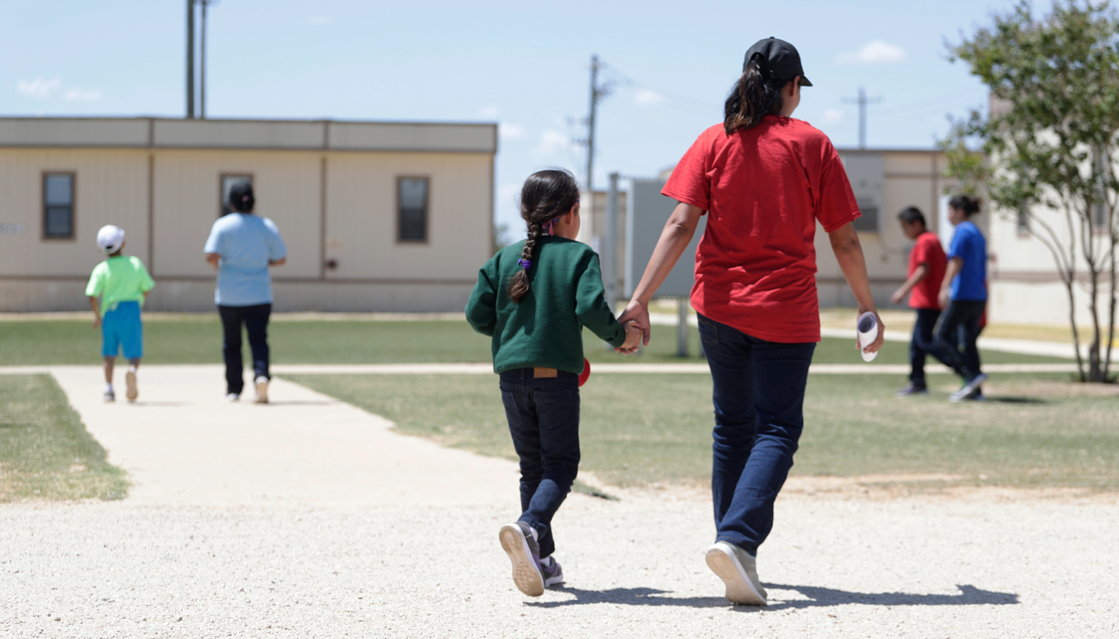 Mother and child walking in family detention center