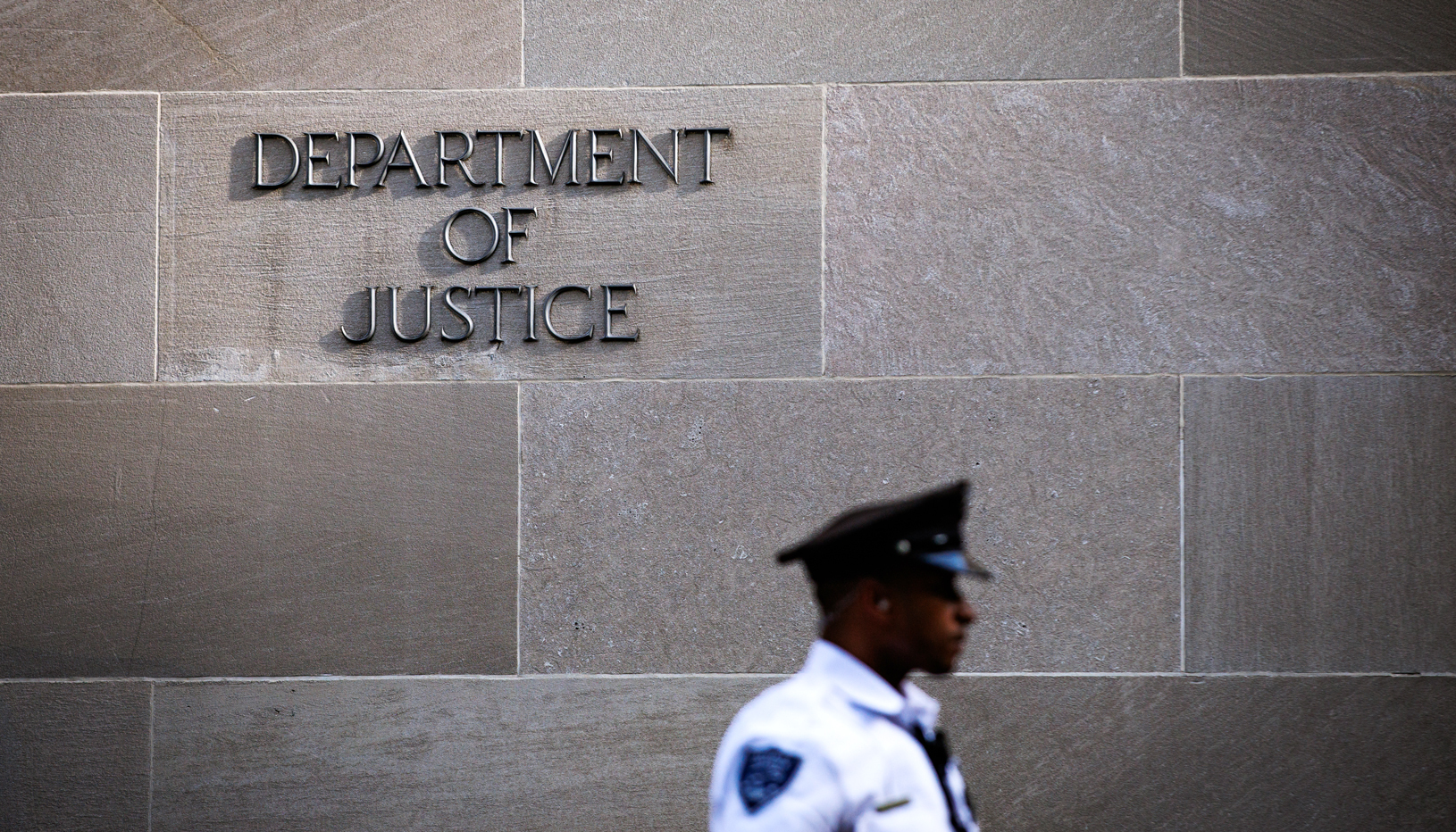 Signage and officer outside the Department of Justice