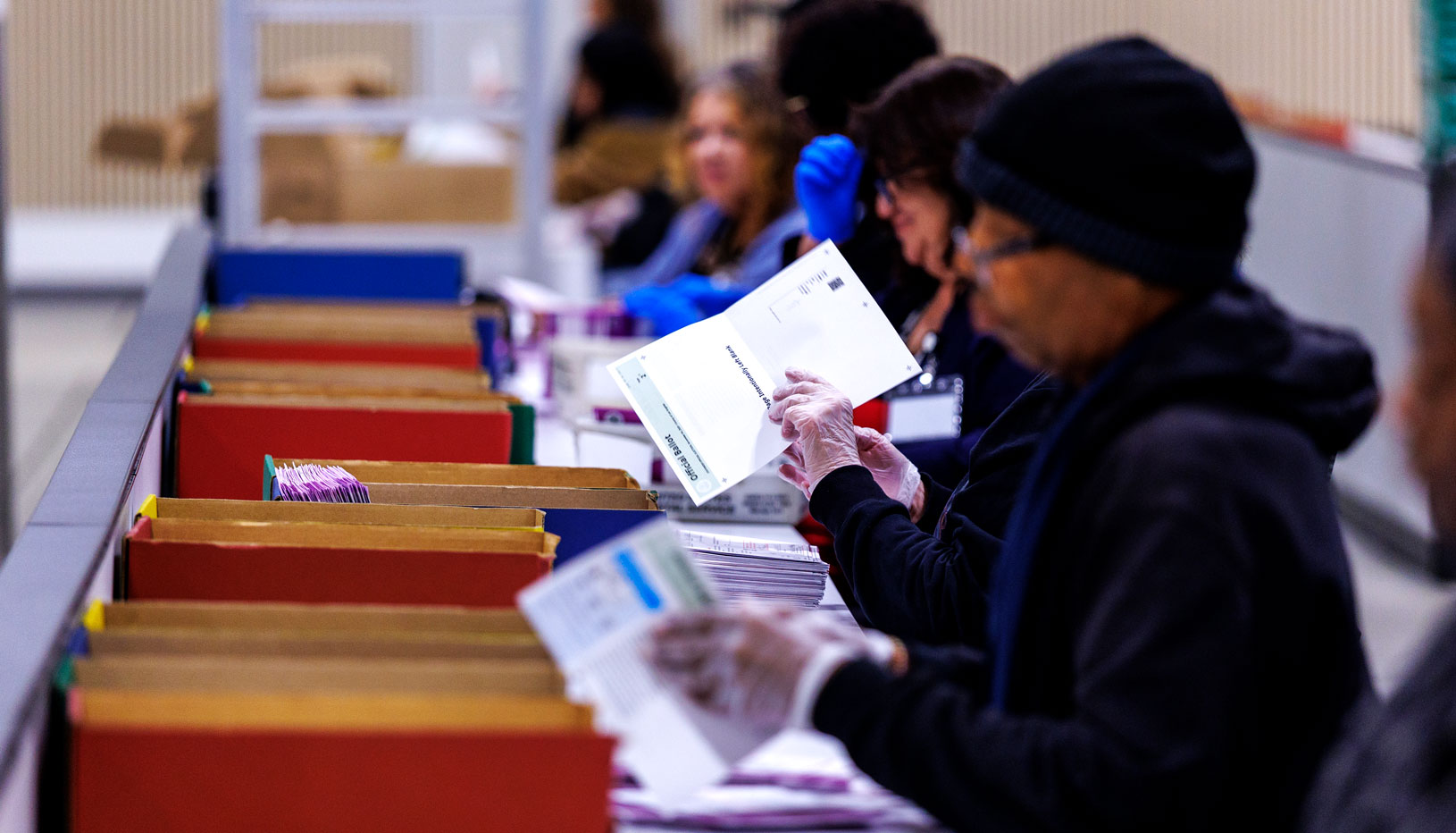 Election workers handling ballots