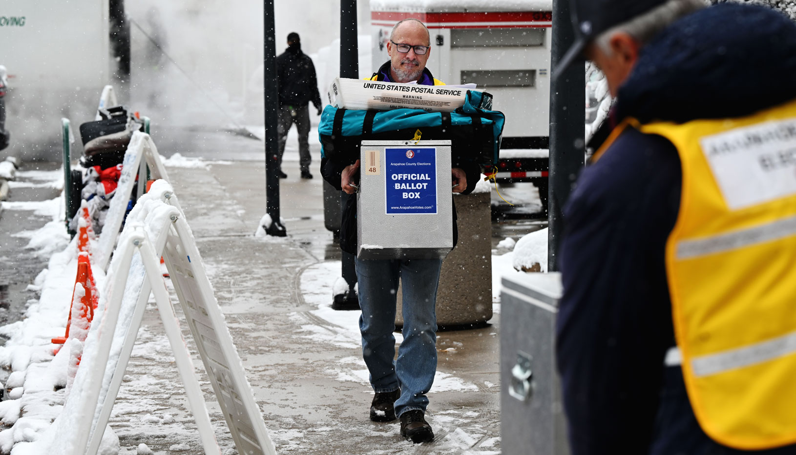 Election worker carrying ballots outside in snow
