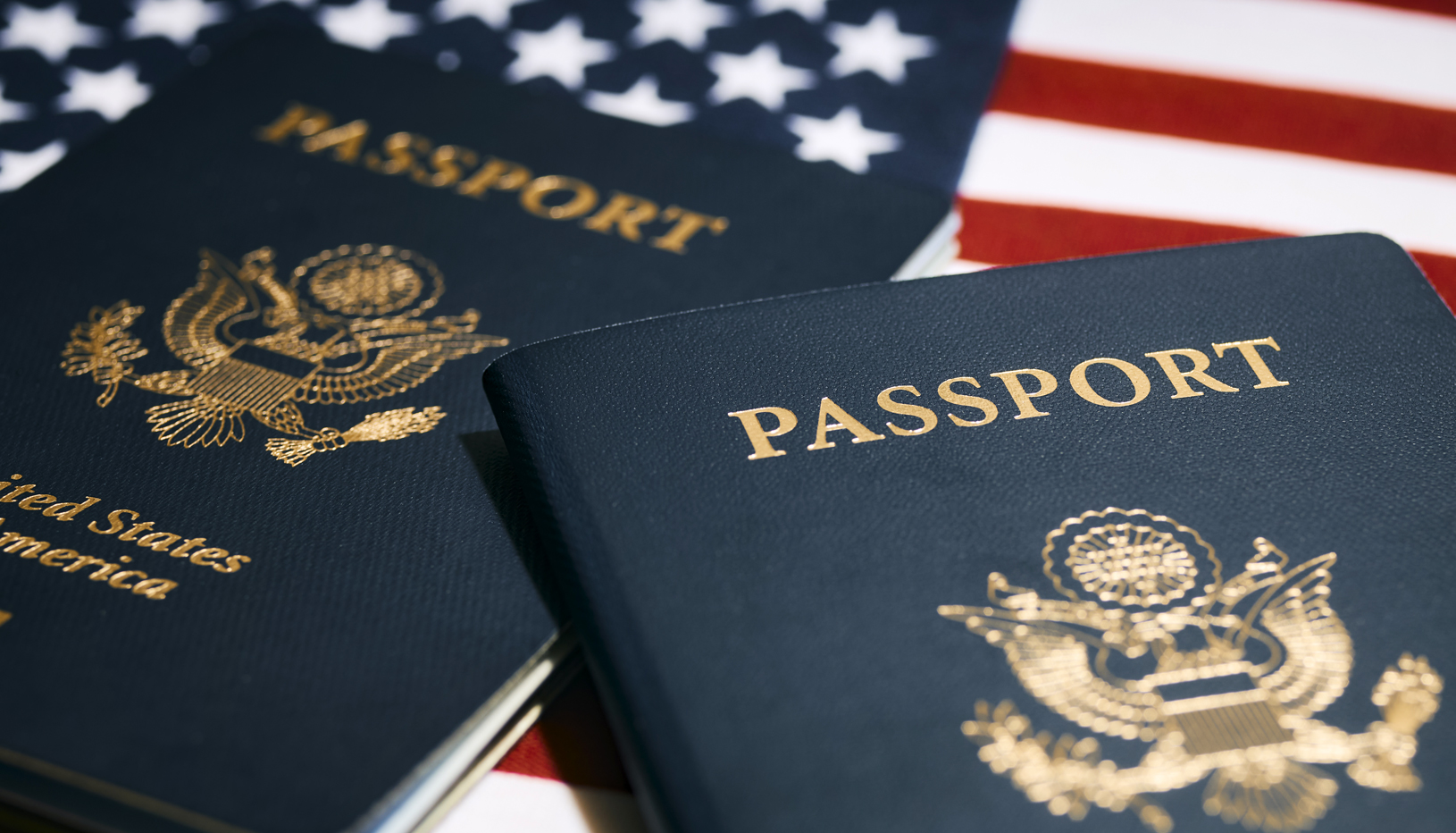 Two U.S. Passports on top of U.S. flag