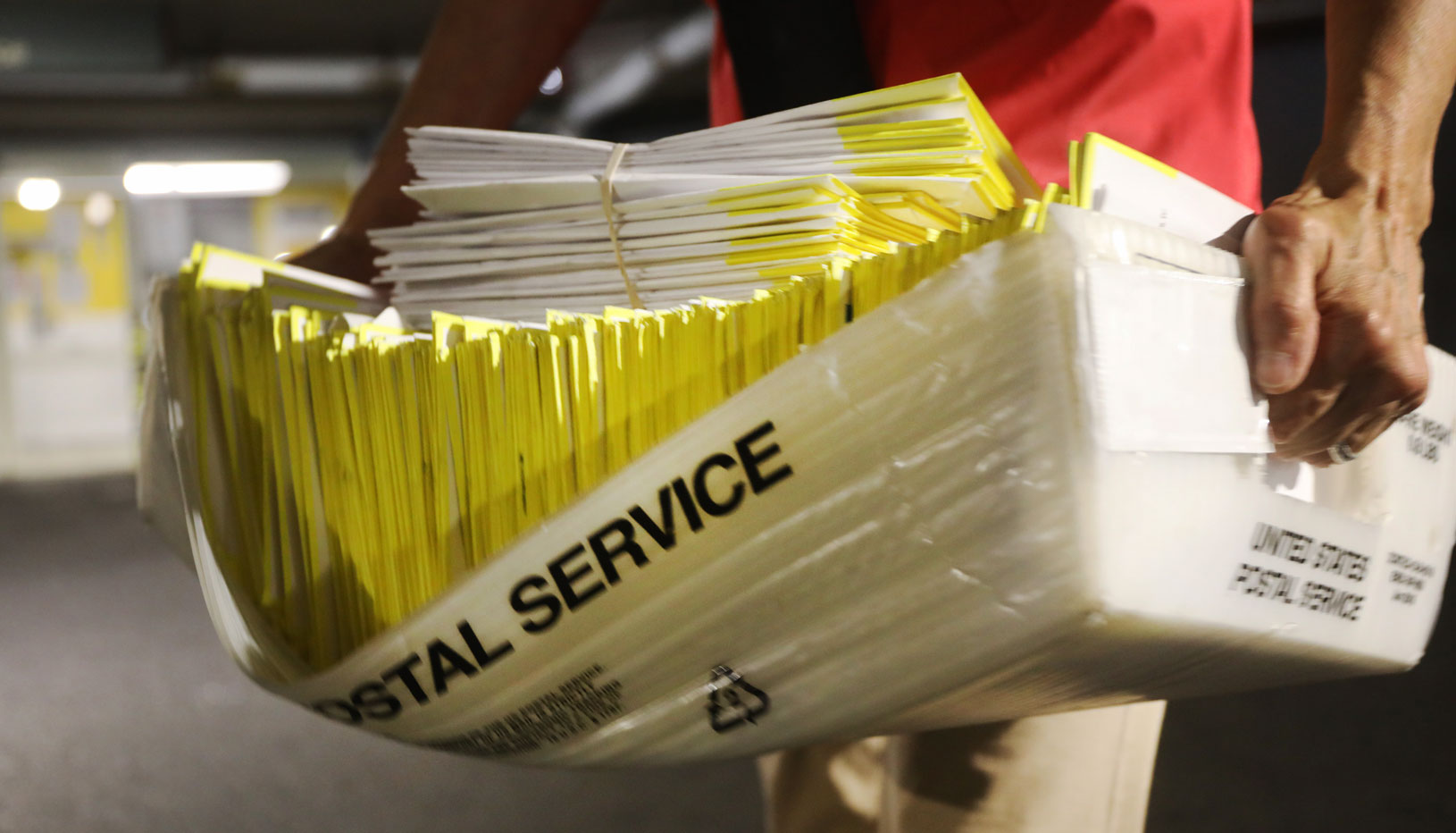 person carrying mail ballots 