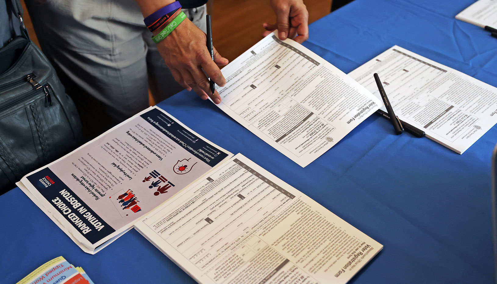 voter registration forms on table with blue tablecloth
