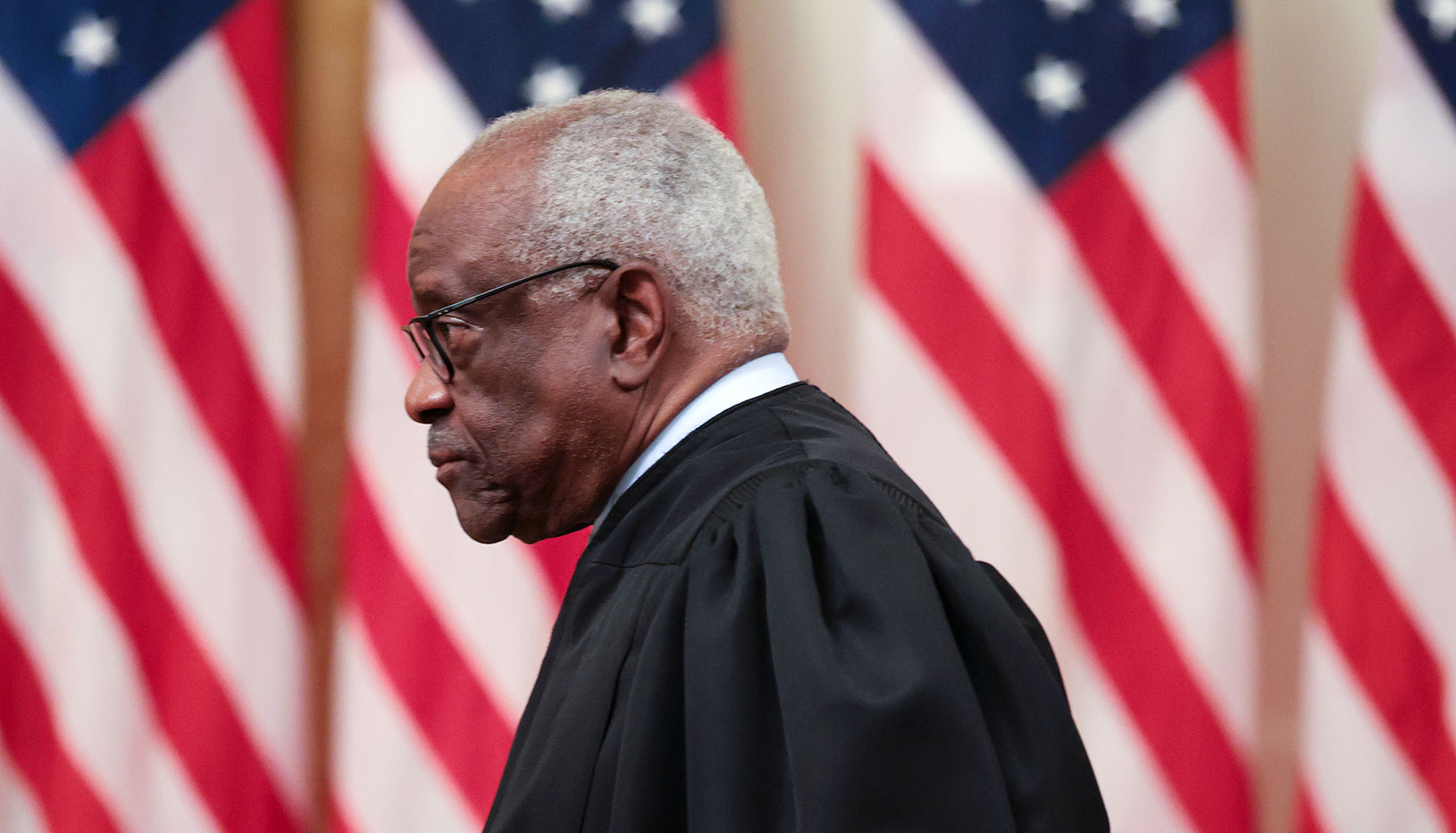 Clarence Thomas with American flags in background