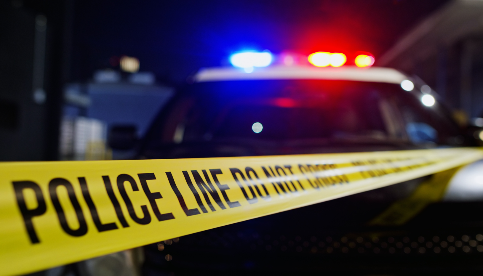 Crime scene tape and police car