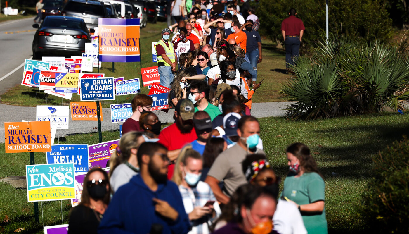 Voters wait in a very long line to vote. 