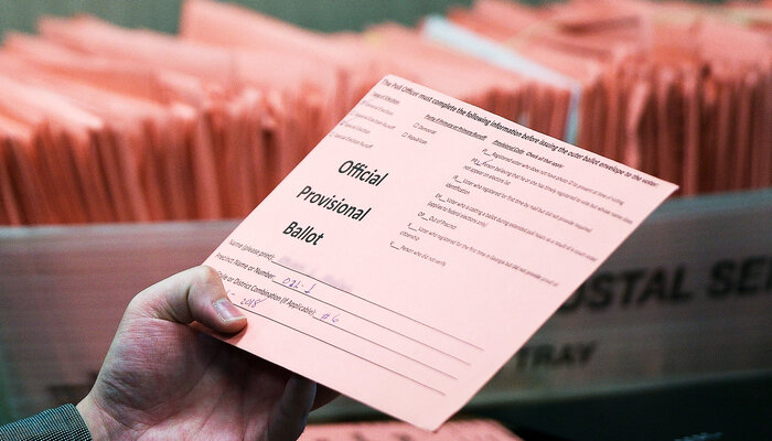 how to change from mail in to in person voting