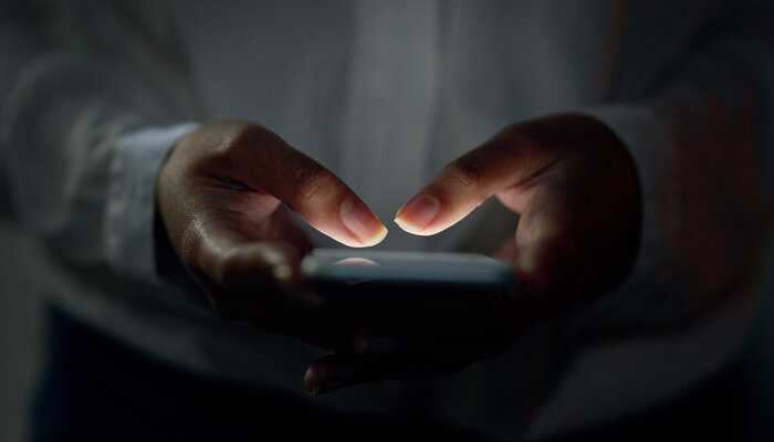 Close-up shot of hands using a cell phone