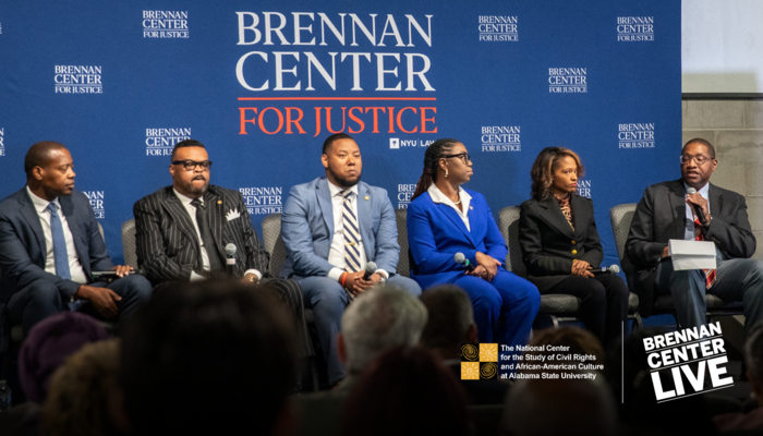 photo of panelists speaking at the live in-person event