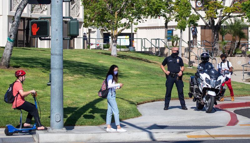 people and cops in a park