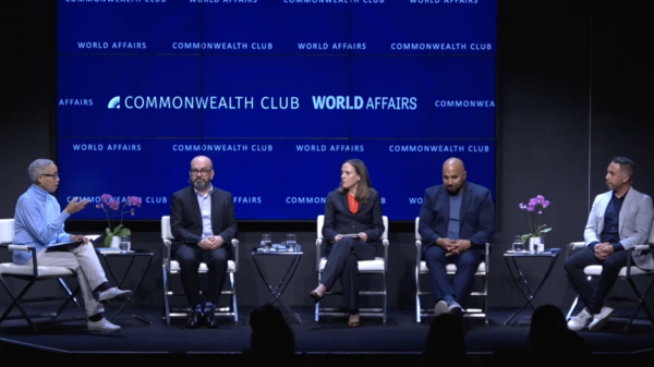 Panel of diverse speakers against deep blue background