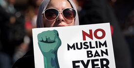 Protestor holding "No Muslim Ban Ever" sign