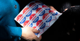 Woman holds "I Voted Today" stickers.