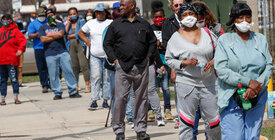 Residents wait in long line to vote in a presidential primary election outside the Riverside High School in Milwaukee, Wisconsin, on April 7, 2020