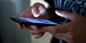 Close-up shot of hands using a cell phone