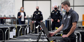 A Clark County election worker checks a voting machine 