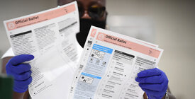 An election worker revises a ballot