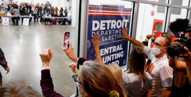 Protestors pound the door of a Detroit elections office