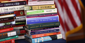 Two piles of books on a table