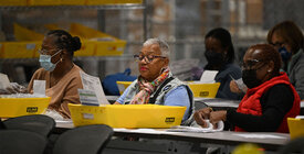 Election workers review documents. 