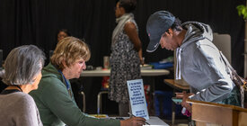 Election workers assisting a voter