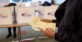 person holding paper ballot