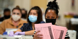 Election workers reviewing ballots