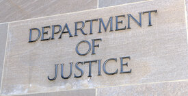 Department of Justice lettering on gray building