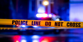 police tape foreground and siren lights