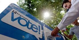 Voter delivering ballot to King County ballot drop box