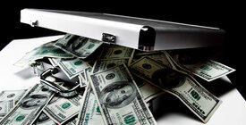 Cash spilling from silver briefcase