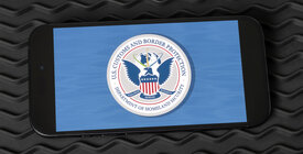 Graphic of DHS seal displayed on a smartphone screen