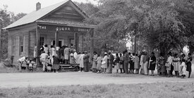 Historical image of Black voters in line at a polling place