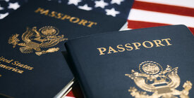 Two U.S. Passports on top of U.S. flag
