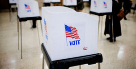voting booth with United States flag on side