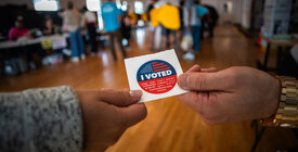 People holding an "I voted" sticker