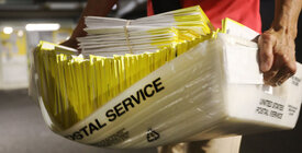 person carrying mail ballots 