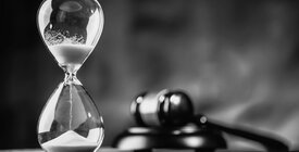 black and white image of hourglass and gavel