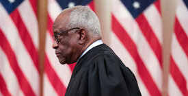 Clarence Thomas with American flags in background