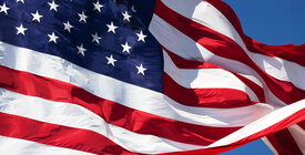 waving American flag against blue sky